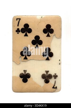 A badly damaged vintage playing card in the suit of clubs isolated on a ...