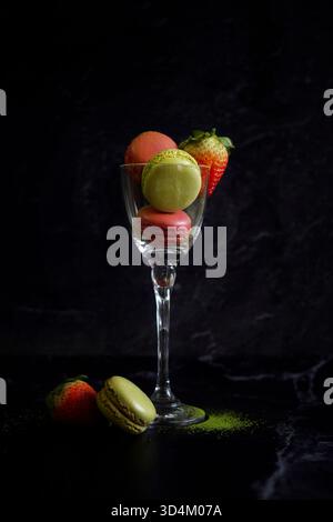 Japanese Matcha and Strawberry Macarons on Black Marble Background. Stock Photo