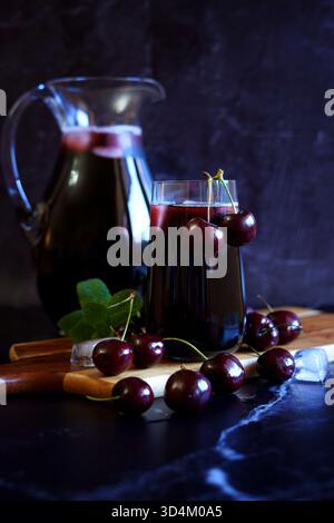 Pure Black Cherry Juice on Dark Background. Stock Photo