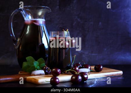 Pure Black Cherry Juice on Dark Background with Negative Copy Space. Stock Photo