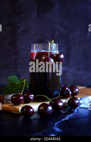 Pure Black Cherry Juice on Dark Background. Stock Photo