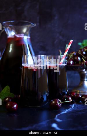 Pure Black Cherry Juice on Dark Background. Stock Photo