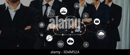 A professional business team showcases a cloud technology concept with digital icons, emphasizing networking and data management in a modern workspace Stock Photo