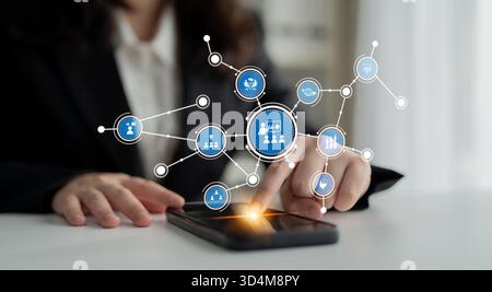 A business professional interacts with a smartphone, showcasing a digital overlay of networking icons, emphasizing technology, communication, and Stock Photo