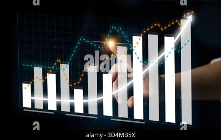 A digital interface depicting a hand interacting with bar charts and trend lines. This image symbolizes financial growth, data analysis, and Stock Photo