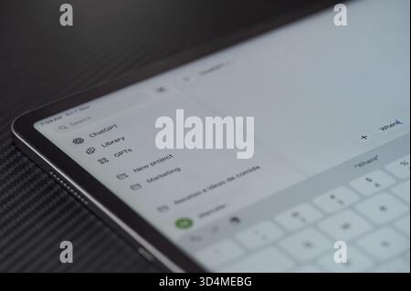 New York, USA - November 7, 2025: Typing question on ChatGPT ai chatbot close up view on dark table Stock Photo
