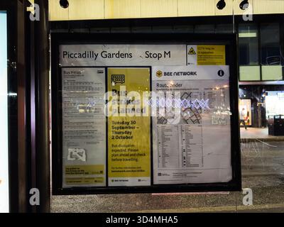 Manchester, UK - September 30, 2025: Public transport posters at a busy Manchester bus stop show planned strikes and schedules. Stock Photo
