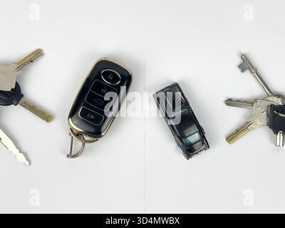 This image features a collection of items related to keys and transportation, arranged on a clean, white surface, likely a flat lay or top-down shot. Stock Photo