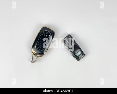 This image features a collection of items related to keys and transportation, arranged on a clean, white surface, likely a flat lay or top-down shot. Stock Photo