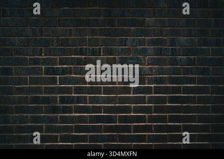Dark brick wall surface used as architectural design and construction background. Decorative black brickwall with modern texture, urban background pat Stock Photo