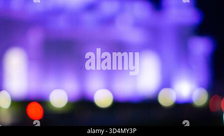 Abstract blurred lights in shades of purple and white creating a soft, dreamy bokeh effect. Stock Photo