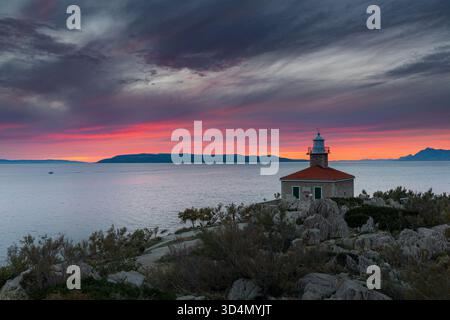 Colorful sunset over lighthouse St. Peter in Makarska Stock Photo