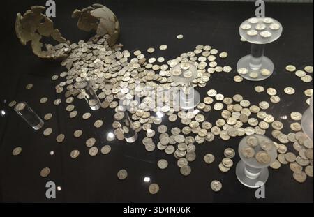 Hoard of coins at the National Roman Legion Museum in the ancient Roman town of Caerleon, Newport, South Wales, UK Stock Photo