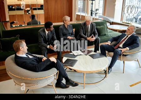 Diverse Group of Middle Aged Business Professionals Discussing Strategy Stock Photo
