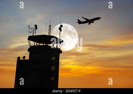 Air Traffic Control Tower at Airport As Airplane Takes Off. Stock Photo
