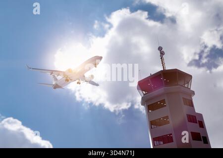 Air Traffic Control Tower at Airport As Airplane Takes Off. Stock Photo
