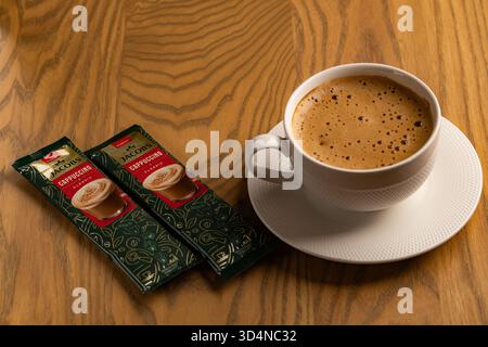 Lviv, Ukraine - November 11, 2025: Overhead View of Hot Cappuccino Cup and Jacobs Instant Sachets Stock Photo