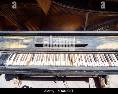 old keys of shabby piano on street in Tbilisi city on sunny summer day, Georgia Stock Photo