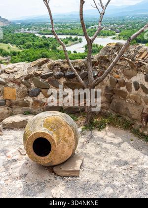 old georgian ceramic amphora (kvevri) for wine and above view of Kura river from Uplistsulis Eklesia (Prince's Church) in Uplistsikhe Cave Town, Georg Stock Photo