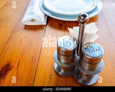 steel salt and pepper spice set with toothpicks on wooden dining table Stock Photo