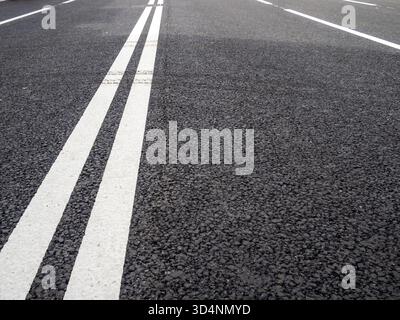 white road markings - double solid line on new asphalt surface of street Stock Photo