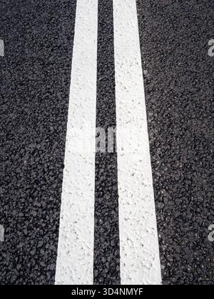 above view of freshly painted double solid lines on new asphalt surface of expressway Stock Photo