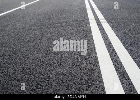 white road markings - double solid line on new asphalt surface of city road Stock Photo