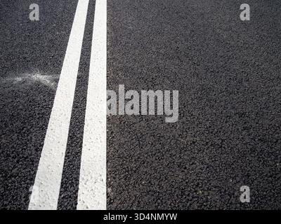 above view of double solid line on new asphalt surface of city highway Stock Photo
