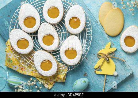 Food, Easter linzer egg cookies with lemon jam filling. Blue background, top view Stock Photo