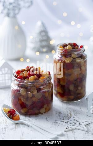 Food, Soaking dried fruits in alcohol, preparing for baking christmas fruit cake or pudding Stock Photo