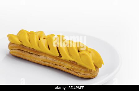 Food, Eclair with Mango Cream on White Plate Stock Photo