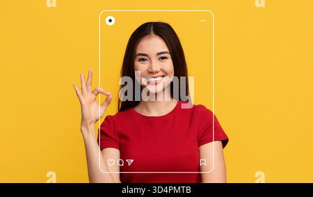 Joyful Woman Making an Okay Sign Against a Bright Yellow Background Stock Photo