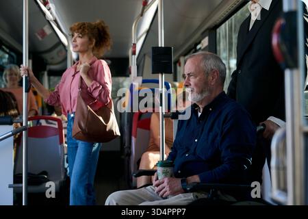 Commuting on bus with senior man in wheelchair Stock Photo