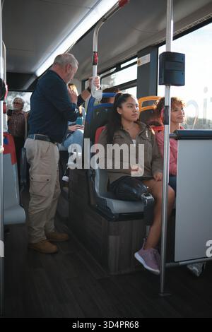 Woman with prosthetic leg commuting on bus Stock Photo