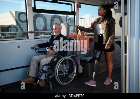 Diverse group of people using accessible public bus Stock Photo