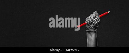 Hand with Red Pencil Tied with Rope in Black and White on Textured Paper Background Banner Stock Photo
