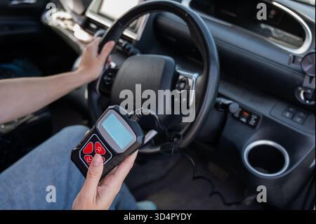 Woman using OBD2 diagnostic scanner.  Stock Photo