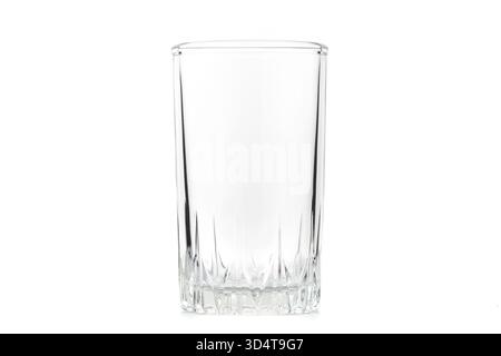A clear glass cup sits on a white background. The cup is empty and has a clean, minimalist appearance Stock Photo