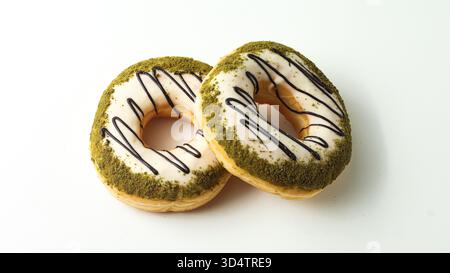 two sweet donuts with macha topping coated in sweet sugar on a white background Stock Photo