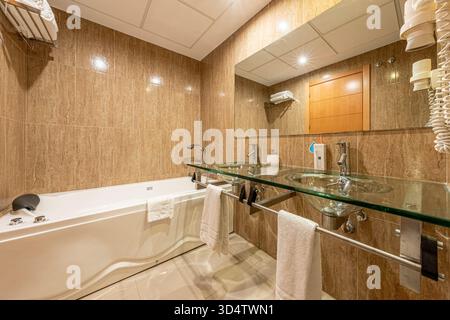 Modern bathroom with a large bathtub and double sink vanity in real estate property Stock Photo