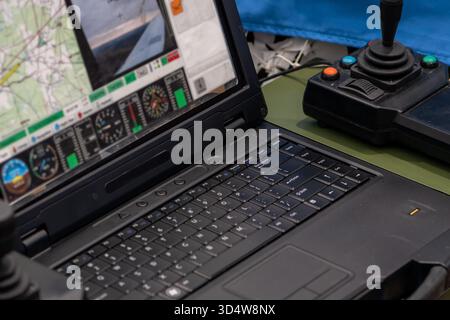 A military laptop with a drone flight control interface and parameter monitoring Stock Photo