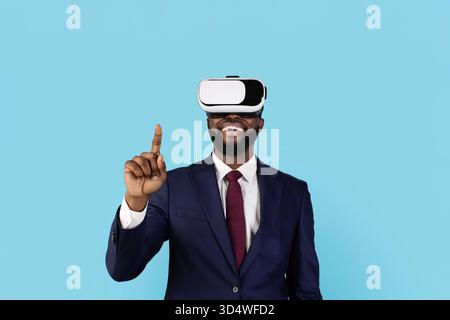 Black Businessman Using VR Glasses And Touching Air With Finger Stock Photo