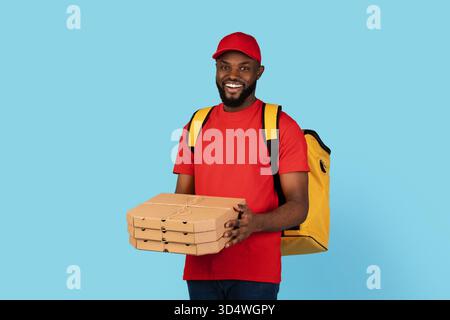 Pizza Delivery. Black Courier Man In Uniform Holding Stack Of Cardboard Boxes Stock Photo