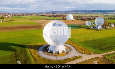 Raisting, Germany - 11 November 2025: Aerial view of the Raisting Earth Station's satellite dishes standing tall against a backdrop of vibrant green f Stock Photo