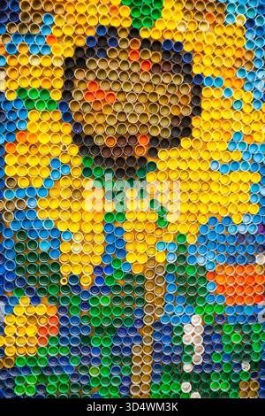 Plastic bottle caps are laid out in a pattern with flowers Stock Photo