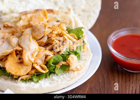 Close-Up of Traditional Turkish Doner Kebab Served in Bread with Fresh Greens and Vegetables Stock Photo
