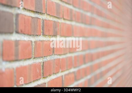 Modern red brick wall with leading lines from sharp to blurred Stock Photo