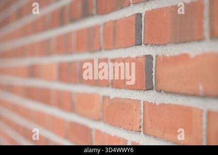Modern red brick wall with leading lines from sharp to blurred Stock Photo