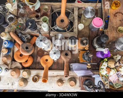 Overhead view of a bustling market stall in Thailand, showcasing a diverse collection of vintage coffee brewing tools, ceramic pottery, and traditiona Stock Photo