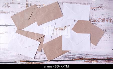Correspondence Chaos: Scattered White and Brown Envelopes on a Rustic Wooden Table Stock Photo